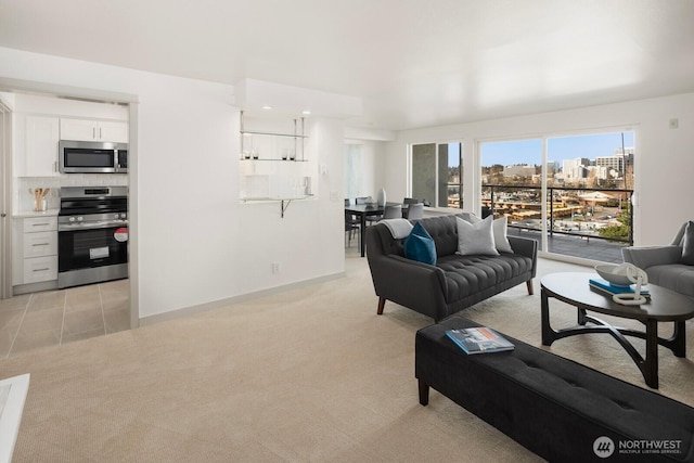 living room featuring a view of city, light carpet, baseboards, and recessed lighting