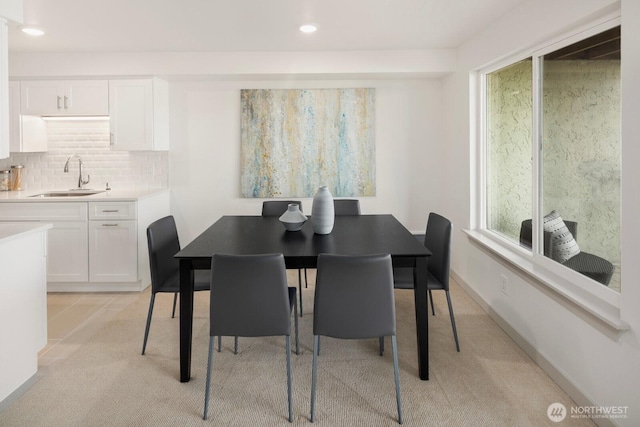 dining room with baseboards, recessed lighting, and light colored carpet