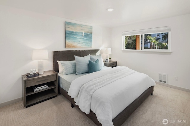 bedroom featuring light colored carpet, visible vents, and baseboards