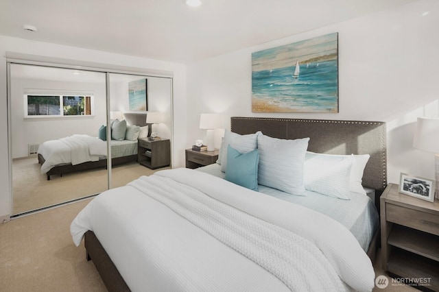 bedroom featuring carpet floors, a closet, and visible vents