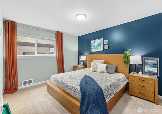 carpeted bedroom featuring visible vents and baseboards