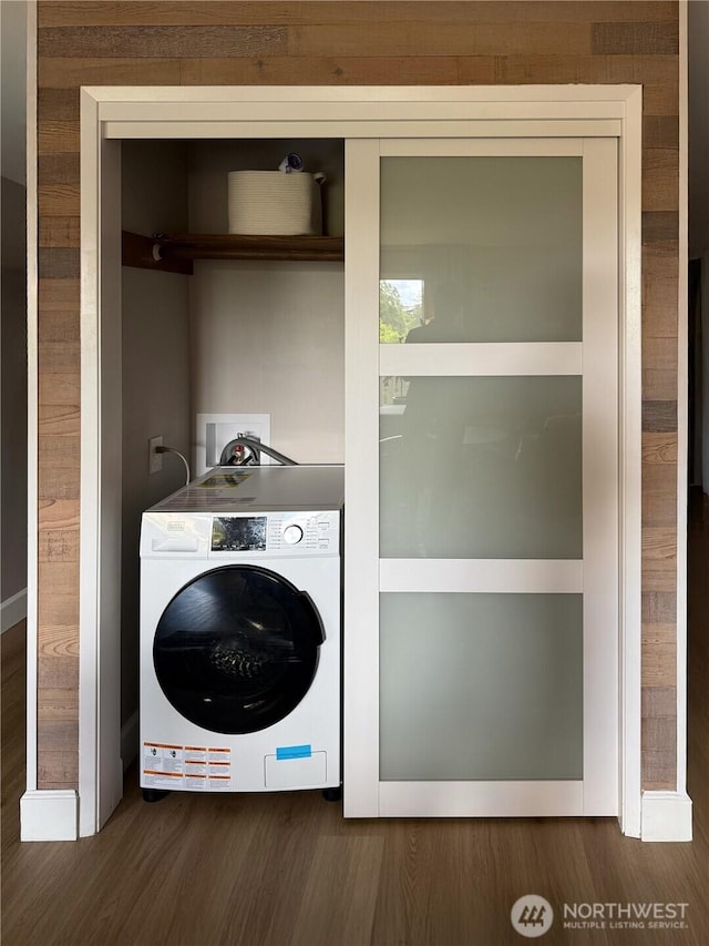 1110 5th Ave S Unit 204, Edmonds, WA 98020 - laundry area with washer / dryer and wood finished floors