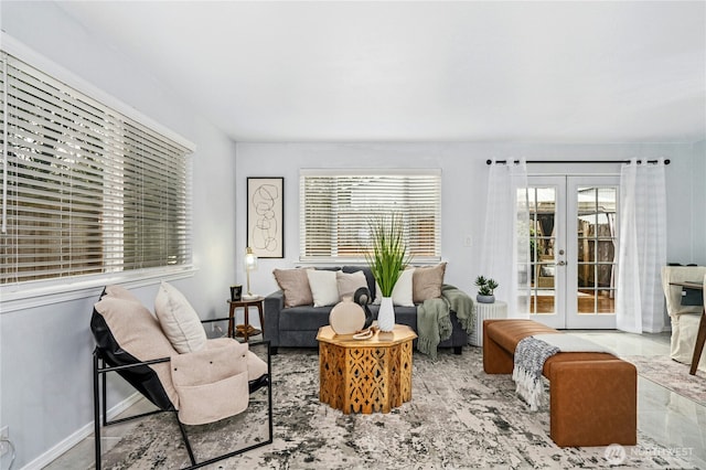 living area featuring french doors and baseboards