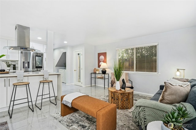 living room featuring recessed lighting, marble finish floor, and baseboards