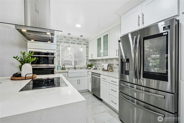 kitchen with light countertops, white cabinets, appliances with stainless steel finishes, and a sink