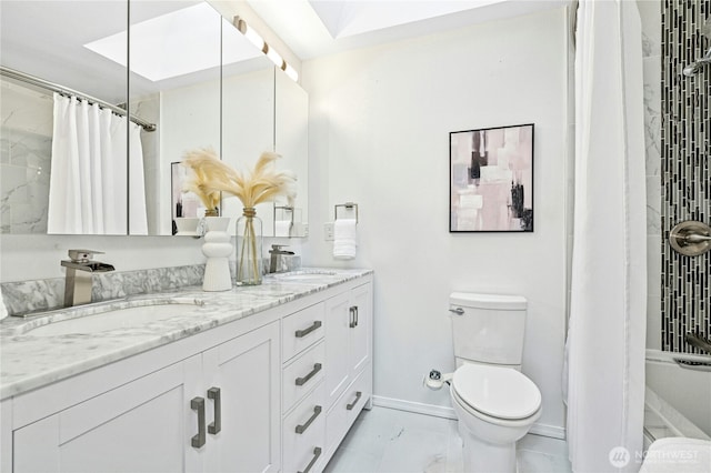 bathroom featuring double vanity, toilet, marble finish floor, and a sink