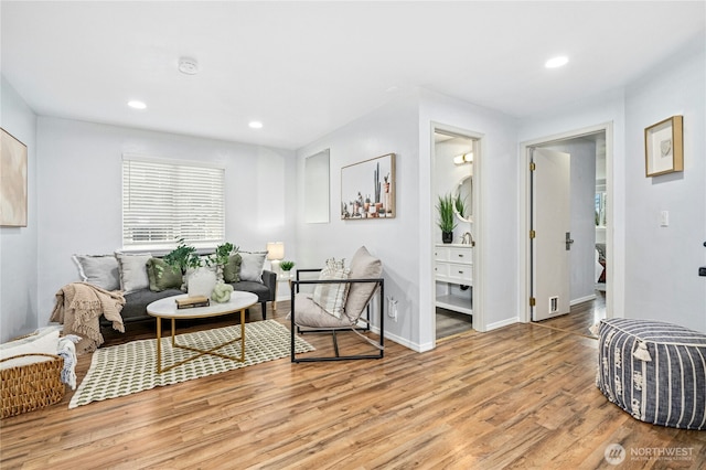 sitting room featuring recessed lighting, light wood-type flooring, and baseboards