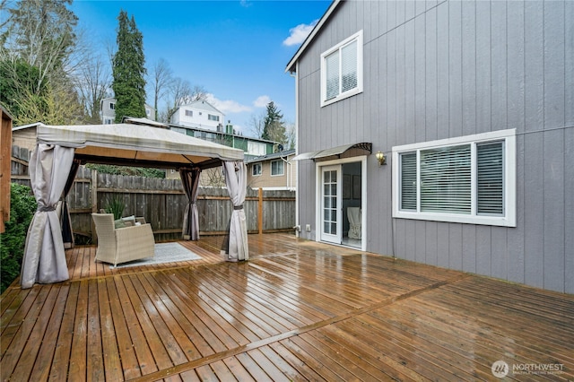 wooden terrace with a gazebo and fence