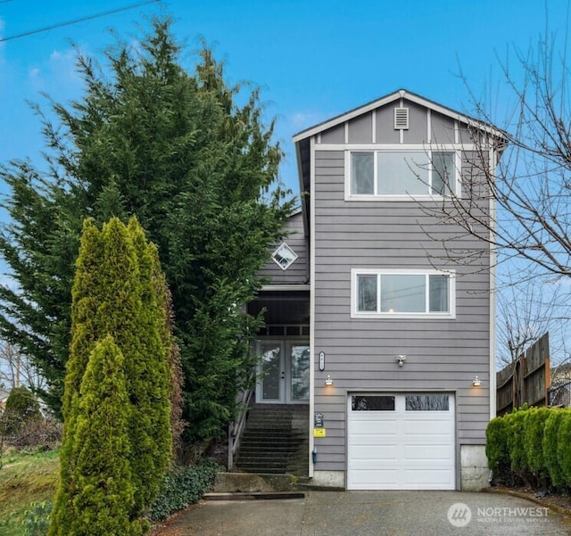 view of front of house with an attached garage and french doors