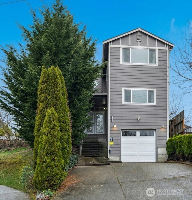 view of front of property with concrete driveway and an attached garage