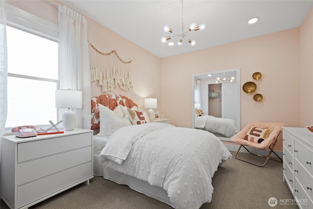 bedroom with carpet floors and a notable chandelier