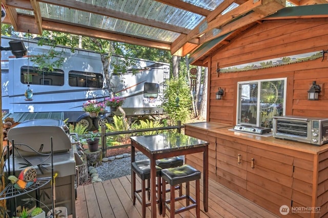 wooden deck featuring a grill