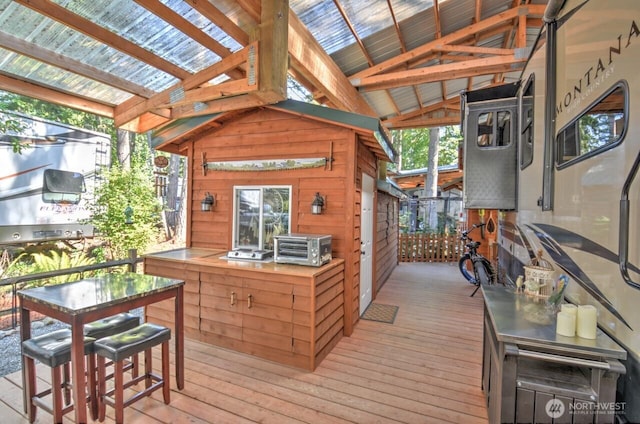 wooden deck with outdoor dry bar