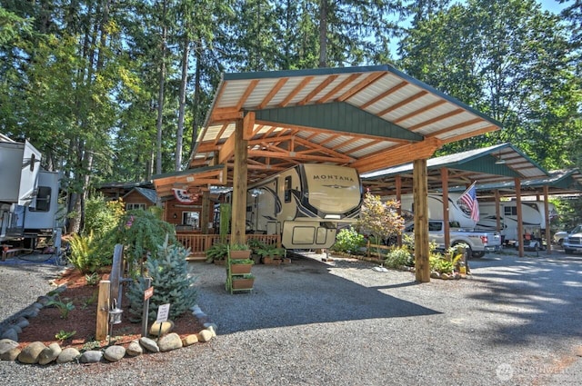 view of parking / parking lot featuring a detached carport