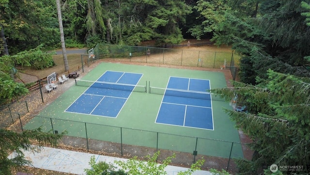 view of sport court featuring fence