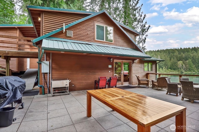 view of patio / terrace featuring a forest view and grilling area