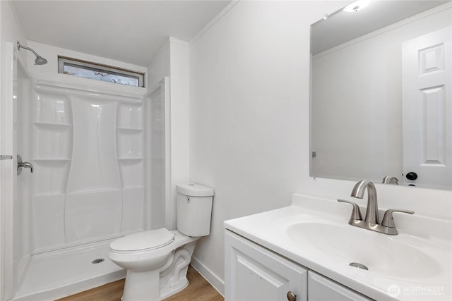 full bathroom with crown molding, toilet, a shower stall, vanity, and wood finished floors