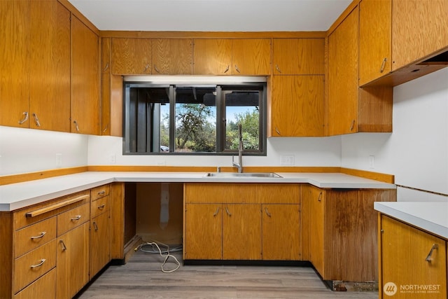 kitchen with brown cabinets and a sink