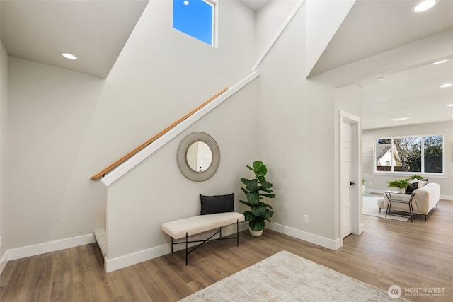 sitting room featuring stairway, recessed lighting, wood finished floors, and baseboards