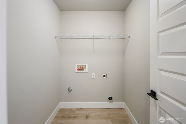 washroom with hookup for a washing machine, hookup for an electric dryer, laundry area, baseboards, and light wood finished floors