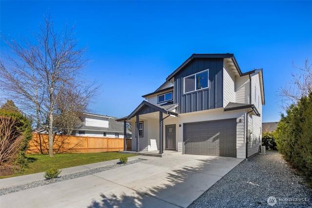 view of front of home with board and batten siding, fence, driveway, and an attached garage