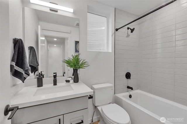 bathroom featuring toilet, vanity, and washtub / shower combination