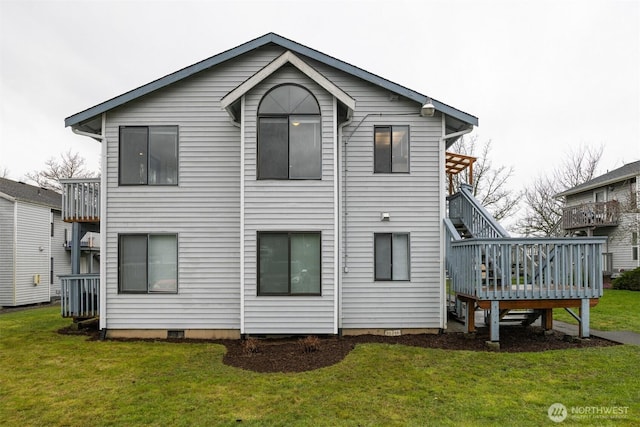 back of property with crawl space, a deck, and a yard