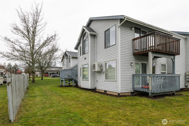 view of side of property with a balcony, ac unit, fence, and a lawn