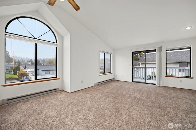 empty room featuring carpet floors, vaulted ceiling, and baseboard heating