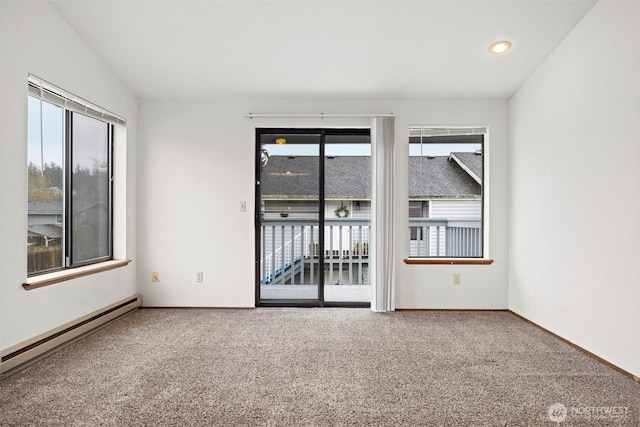 carpeted empty room featuring a baseboard radiator and baseboards