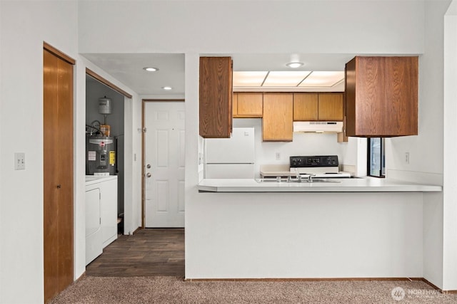 kitchen with water heater, dark carpet, freestanding refrigerator, range with electric cooktop, and under cabinet range hood