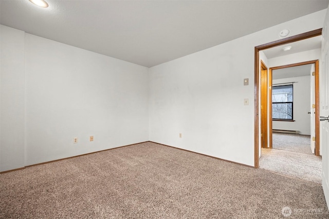 carpeted spare room featuring baseboards and baseboard heating