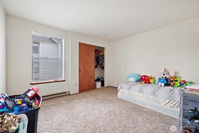 bedroom with a closet, carpet flooring, and baseboard heating