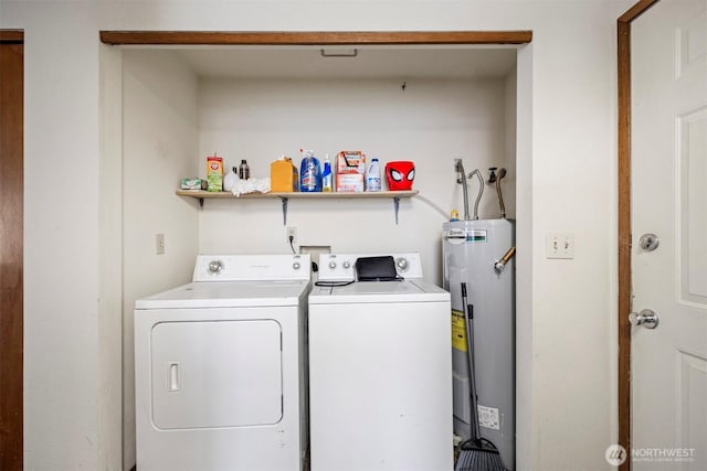 laundry area featuring water heater, laundry area, and separate washer and dryer