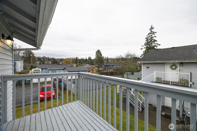 wooden terrace with a residential view and a yard