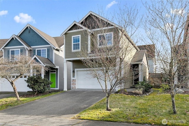 craftsman-style house with a garage, aphalt driveway, and a front yard