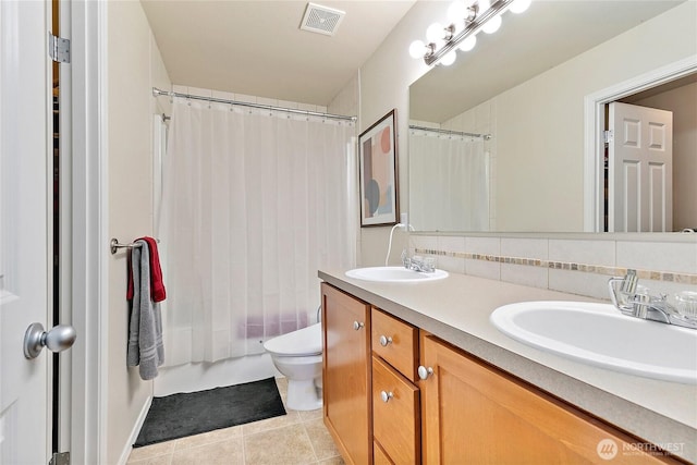 bathroom with visible vents, backsplash, a sink, and tile patterned floors