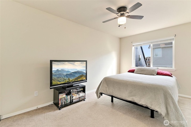 carpeted bedroom featuring baseboards and a ceiling fan