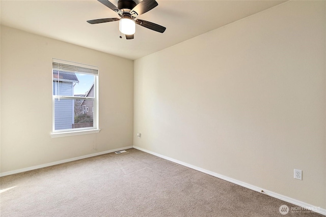 empty room with ceiling fan, carpet floors, and baseboards