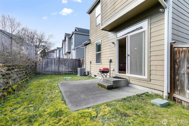 view of yard with a patio area, a fenced backyard, a residential view, and central AC