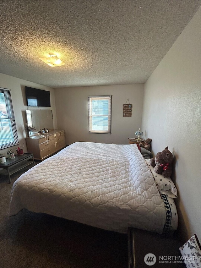 carpeted bedroom with a textured ceiling