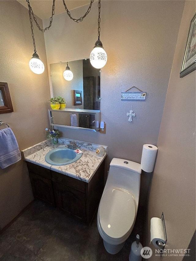 bathroom featuring toilet and vanity