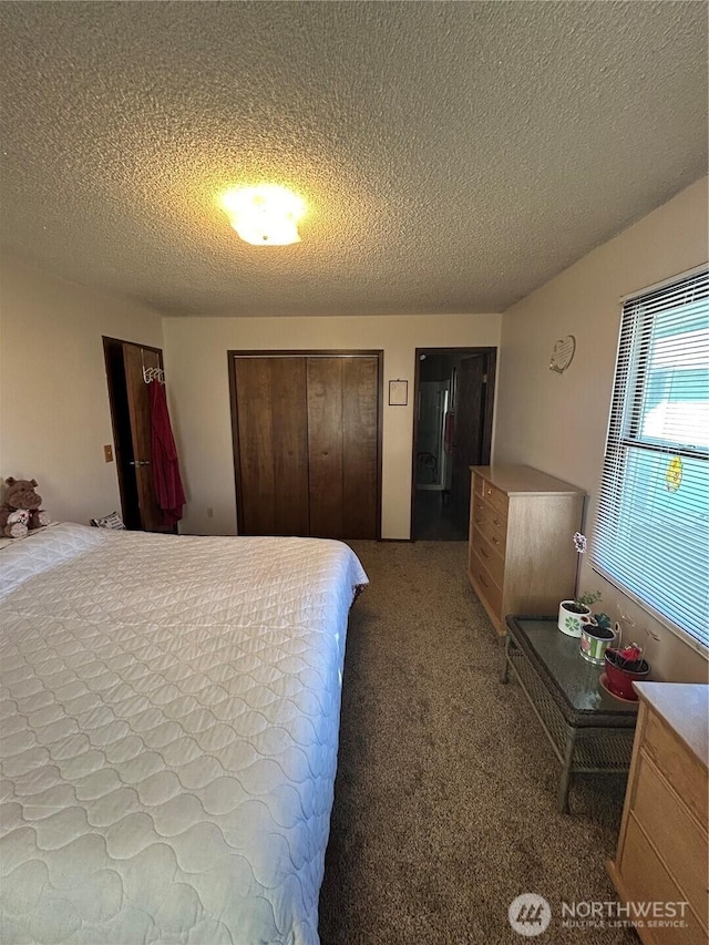 carpeted bedroom featuring a textured ceiling