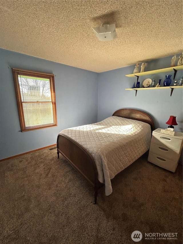 carpeted bedroom featuring baseboards and a textured ceiling