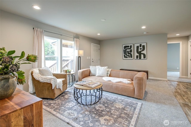 living room featuring baseboards, wood finished floors, and recessed lighting