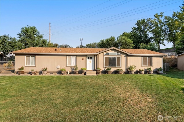 single story home featuring fence and a front lawn