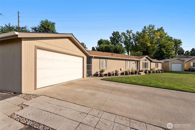 single story home featuring a front yard, concrete driveway, and an attached garage