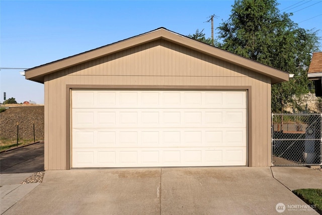 detached garage featuring fence