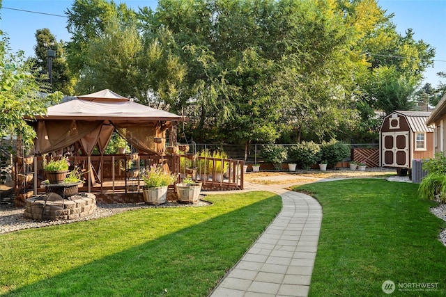 view of yard with central AC unit, a fenced backyard, a gazebo, a storage unit, and an outdoor structure