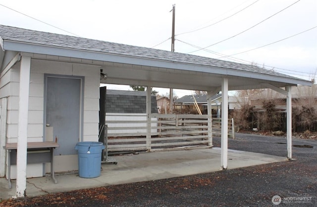 exterior space with fence and a carport